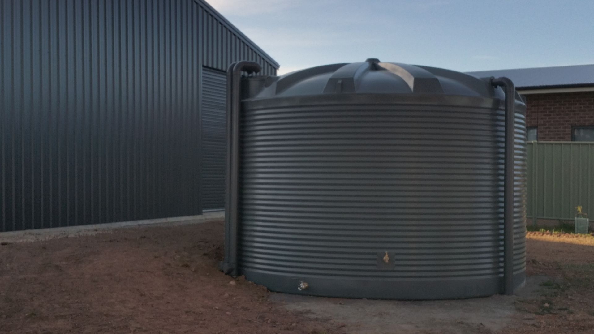 Round poly water tanks installation in Bendigo